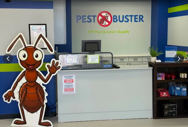 Pest Buster DIY pest control products display and ant mascot cutout in Montgomery TX storefront